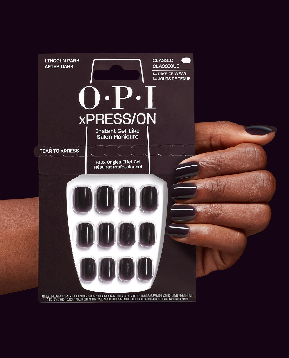 OPI xPRESS/ON Lincoln Park After Dark press-on nails in deep black-plum, shown on a hand beside the 14-day wear package, a dramatic choice for fall nail colors.