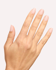 Hand displays glossy pastel pink manicure with OPI Mod About You Pastel gel nail polish on short rounded-square nails against a clean white background, a soft option for fall nail colors.