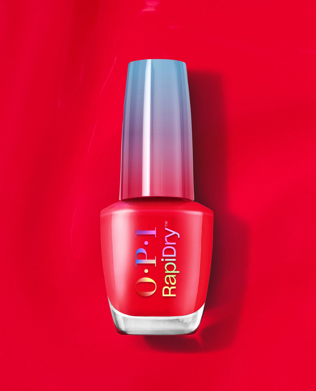 OPI RapiDry nail polish in Haul Sass stands upright, showcasing a vibrant red fall nail color with a metallic gradient cap on a glossy red background.