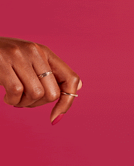 Manicured hand with gold rings flexing against a hot pink background, showcasing glossy magenta Red-Veal Your Truth nail lacquer, styled like an OPI nail polish shade for a bold, salon-quality look.