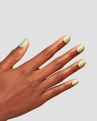 Mint-green manicure showcasing OPI AppointMINT Confirmed nail lacquer, a soft shimmery green nail polish, on neatly filed short nails, hand angled against a clean light gray background, perfect for spring nail colors.